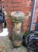 A carved sandstone sundial, supported on an octagonal base