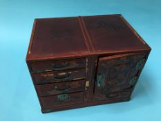 An Oriental lacquered table screen and a lacquered jewellery cabinet