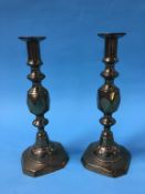 A pair of brass King of Diamonds candlesticks