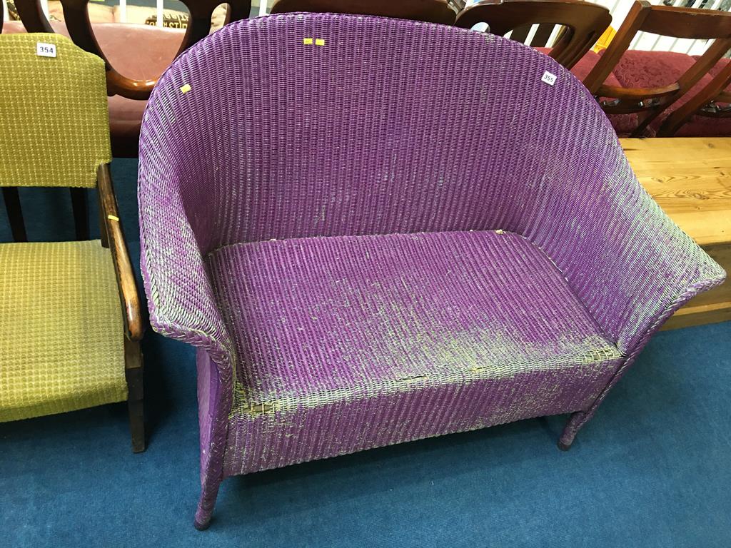 A purple Lloyd Loom two seater settee