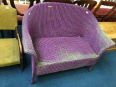 A purple Lloyd Loom two seater settee