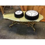 An onyx coffee table, with heavy ornate brass base