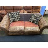 A tan brown three seater Chesterfield and cloth settee