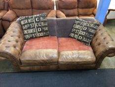 A tan brown three seater Chesterfield and cloth settee