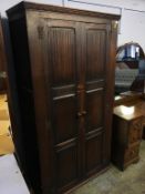 An oak linenfold wardrobe