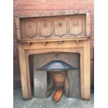 An Arts and Crafts oak fire surround, with copper hood, 143cm wide x 179cm high