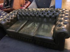 A green Chesterfield three seater settee