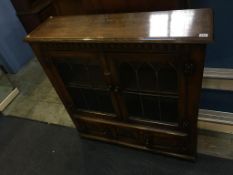 An oak leaded glass bookcase