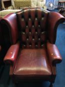 An oxblood Chesterfield high back armchair