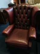 An oxblood Chesterfield high back armchair