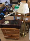 A pine chest of drawers, a clock and two lamps