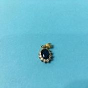An 18ct (750) gold, diamond and sapphire pendant