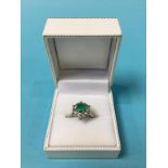 An 18ct white gold diamond and emerald ring, size 'J'