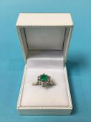 An 18ct white gold diamond and emerald ring, size 'J'