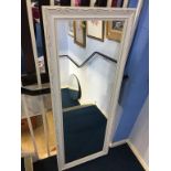 A large white framed mirror