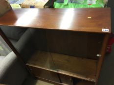 A teak sliding door bookcase