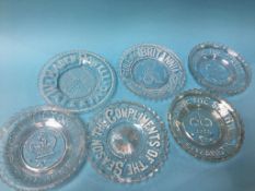 A collection of clear glass commemorative plates