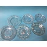 A collection of clear glass commemorative plates