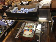 A smoked glass top coffee table with brass coloured base