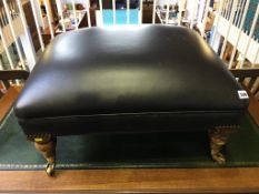 A brown leather top footstool
