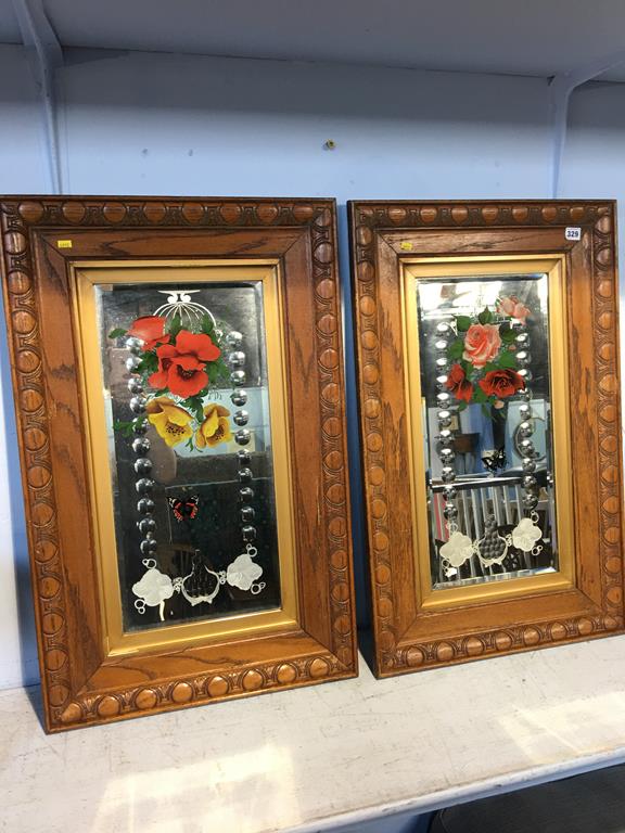 A pair of oak framed Victorian painted glass mirrors