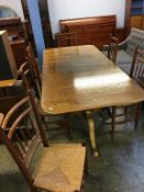 A light oak twin pedestal dining table with a set of six single country style chairs