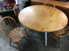 An Ercol drop flap table and four hoop back chairs