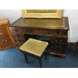 A reproduction mahogany pedestal desk and a piano stool