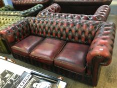 A Chesterfield oxblood three seater settee