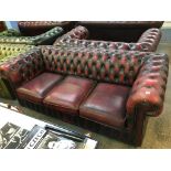 A Chesterfield oxblood three seater settee