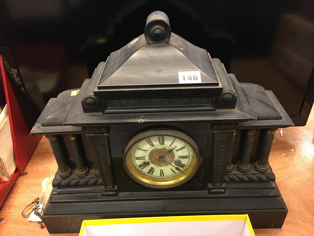 An ebonised mantle clock