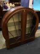 An Art Deco walnut circular design china cabinet