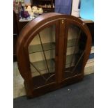 An Art Deco walnut circular design china cabinet