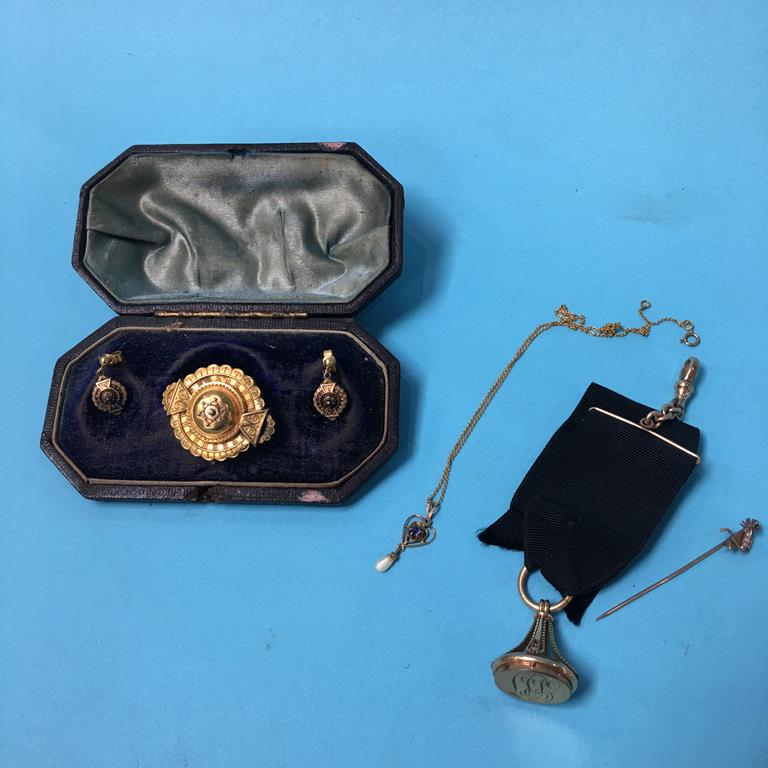 A 15ct brooch and earrings, total weight 5.5 grams, and a gold coloured fob etc.