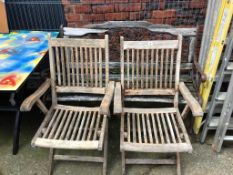 A pair of garden chairs and a bench