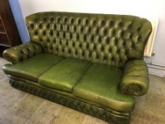 A green leather high back Chesterfield three seater settee