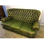 A green leather high back Chesterfield three seater settee