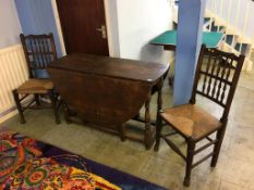 An oak gateleg table and a pair of spindle back chairs