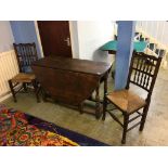 An oak gateleg table and a pair of spindle back chairs