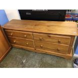 A low pine chest of drawers