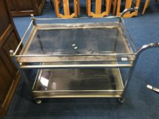 A chrome and smoked glass two tier tea trolley