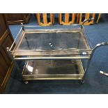 A chrome and smoked glass two tier tea trolley