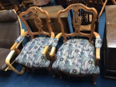 A pair of decorative open armchairs