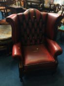 An oxblood Chesterfield leather high back armchair