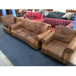A brown leather three piece suite and foot stool