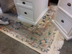 A beige Chinese design rug