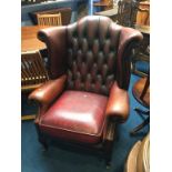 An oxblood Chesterfield leather high back armchair