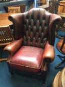 An oxblood Chesterfield leather high back armchair