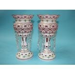 A pair of Victorian opaque glass lustres, flashed with cranberry and decorated with rose heads and