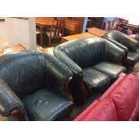 A green leather three piece suite